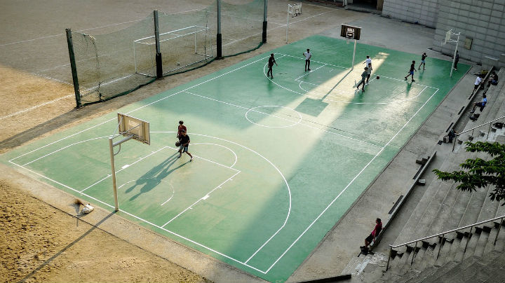 boys playing on outdoor basketball court
