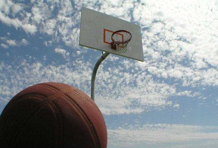 basketball on free outdoor court under cloudy sky