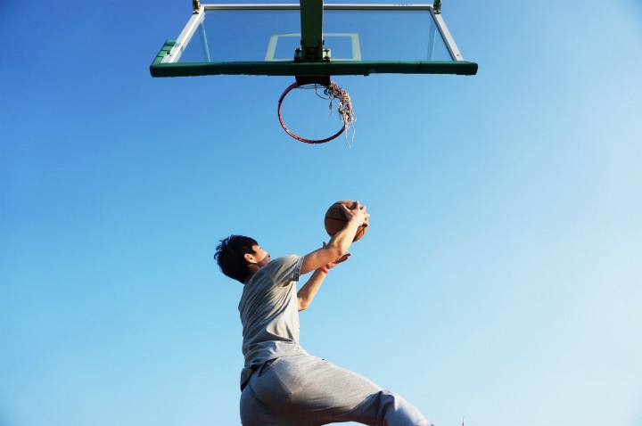 basketball player shooting under basket outdoor