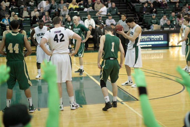 player in white jersey taking free throw in basketball game