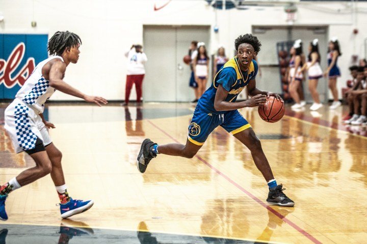 man in blue jersey playing basketball