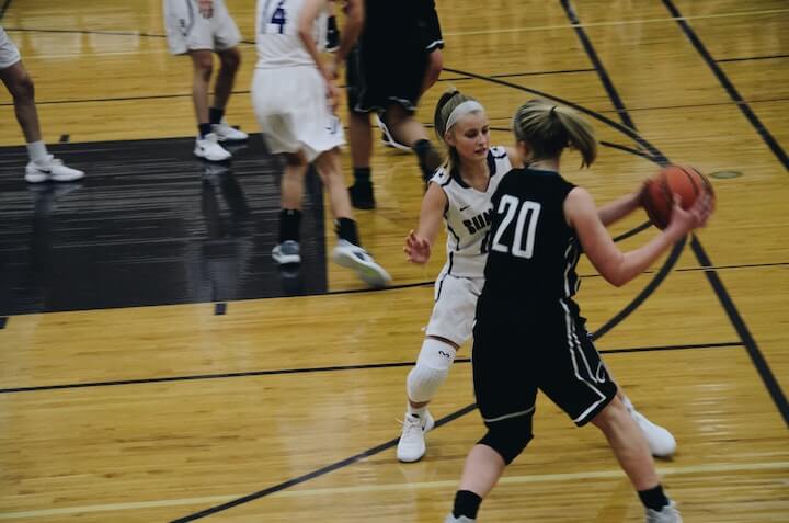 female-basketball-player-guards-the-dribble-handoff-during-a-game