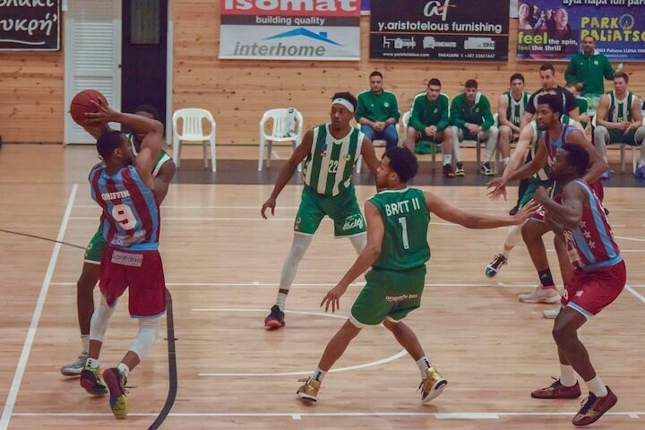 Assist in Basketball Basketball player looks to assist to a teammate during a game