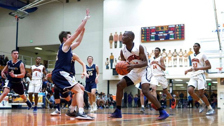 player-in-triple-threat-position-in-lane Offensive basketball player in triple threat position getting ready to shoot the ball against a defender.